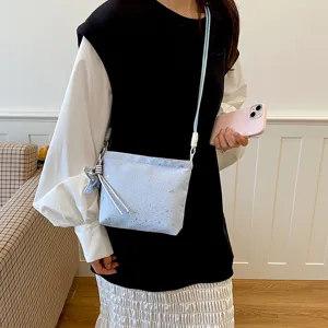 Light blue women's crossbody shoulder bag with star pattern and cute charm for daily commute.