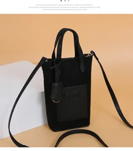 Black suede mini crossbody phone bag with top handle, front pocket detail and slim strap.