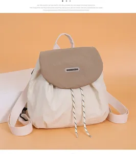 Detail view of the sweet color-blocking canvas backpack flap and drawstring closure.