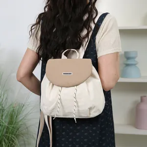Canvas contrast color backpack for women, casual school bookbag viewed from back.
