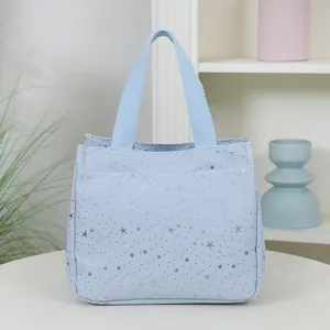 Light blue tote bag with silver star print, stylish casual handbag for daily commute and travel.
