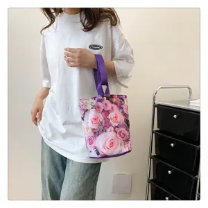 Casual canvas bucket handbag with purple handles and pink rose floral print, lightweight daily tote.
