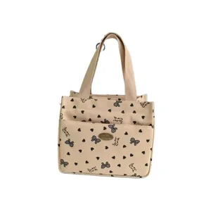 Beige canvas handbag with cute bow heart print, large capacity tote bag for daily work or lunch.