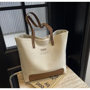 Canvas tote bag for women, stylish minimalist shoulder bag with leather contrast for daily commute.