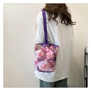 Detailed view of the floral canvas bucket bag worn on shoulder, showing pink rose print.