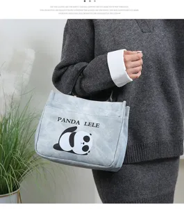 Close-up detail of the cute cartoon panda PU leather handbag, waterproof daily lunch bag.