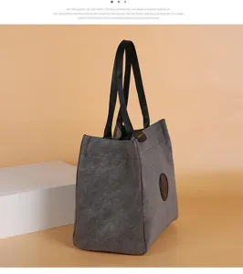 Dark grey canvas tote bag with black web handles, stylish niche design for daily use.