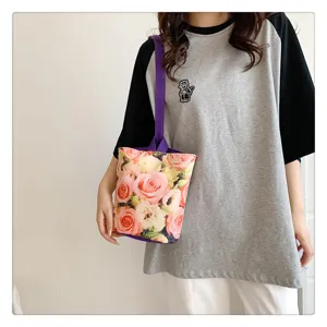 Detailed view of a small floral canvas bucket bag with purple handle, stylish daily tote.