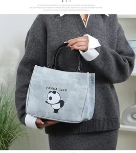 Detail shot of a stylish PU leather handbag featuring a cute cartoon panda print for daily use.