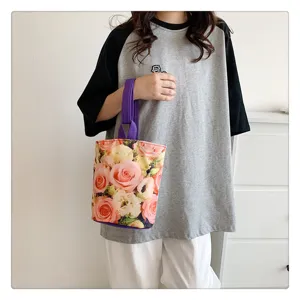 Canvas bucket bag with vibrant rose floral print, purple handle, casual handbag for daily use.