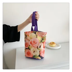 Close-up detail of the floral canvas bucket bag with purple straps, stylish bento handbag.