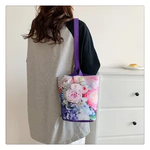 Floral canvas bucket bag for women, casual single shoulder tote bag with purple strap.