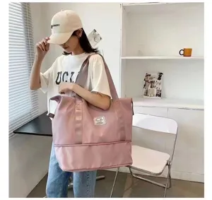Details of large capacity pink travel duffel bag, showing the spacious interior and bottom compartment.