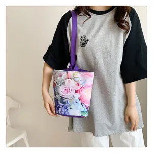 Floral print canvas bucket bag with purple handle, casual portable handbag for daily use.