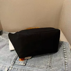 Black canvas tote bag, versatile daily handbag for women, casual commuter lunch bag.