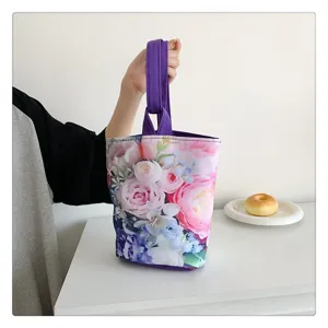 Beautiful floral print canvas bucket bag detail shot showing delicate rose pattern and purple handle.