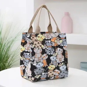 Cute cartoon cat print canvas lunch bag with double handles, perfect for daily commuting use.