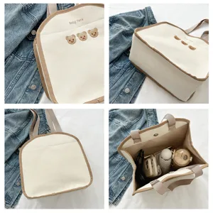 Korean style canvas tote bag with cute bear embroidery and brown trim for daily use.
