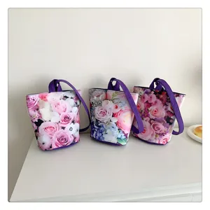 Detail view of floral print canvas bucket bag with purple handle, perfect for daily casual use.