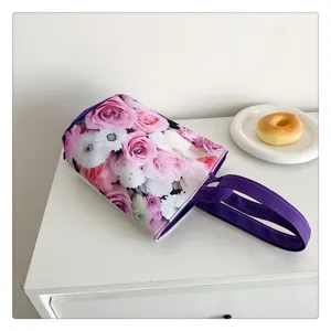 Canvas floral lunch handbag detail showing stunning pink roses pattern and purple handle.