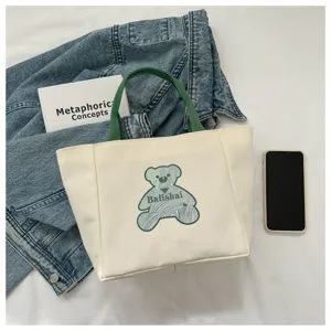 Casual canvas tote bag for women, stylish minimalist shoulder bag with bear print and green handles.
