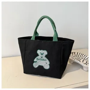 Black canvas tote bag for women, stylish casual handbag with green handle and cute bear print.
