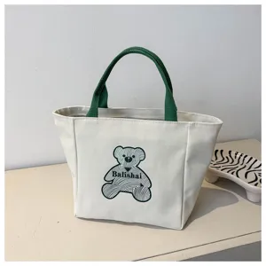 Canvas tote bag for women, stylish casual handbag with cute bear print and green top handles.