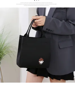 Black canvas lunch bag with cute anime girl graphic, portable tote for daily use and work.