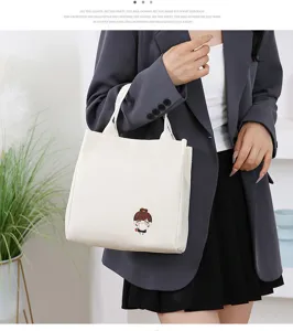 Cute canvas tote bag with cartoon character patch, lightweight student bento lunch handbag.