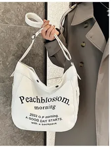 White canvas tote bag for women, large capacity single shoulder commuter handbag.