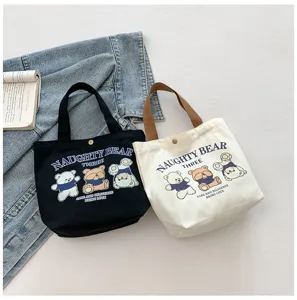 Detailed close-up of casual canvas tote bags with cute bear print and sturdy handles for daily use.
