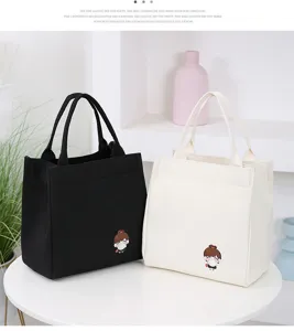 Cute canvas lunch bag with cartoon girl design, large capacity tote for daily use and school.