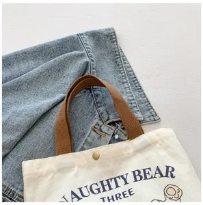 Casual canvas tote bag for women, stylish shoulder handbag with sturdy handles for daily use.