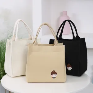 Cute canvas lunch bag with cartoon girl design, large capacity tote for daily use.