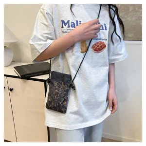 Detail shot of a retro floral print crossbody mobile phone bag for women, casual vintage style