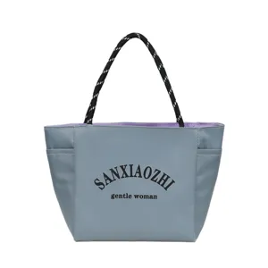 Grey tote handbag with rope handles and bold front text, casual daily commuter shoulder bag.