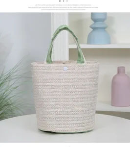 Woven straw handbag for women, casual summer beach tote bag with green handles and snap closure.