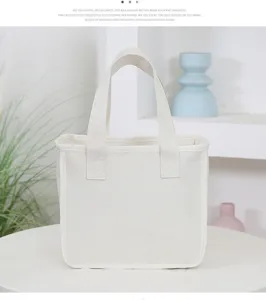 Detail shot of thick canvas lunch tote bag in neutral off-white color with sturdy dual handles.