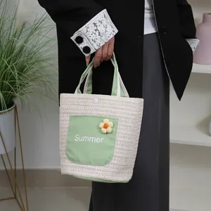 Straw woven tote bag with green pocket and floral decor for women beach summer use
