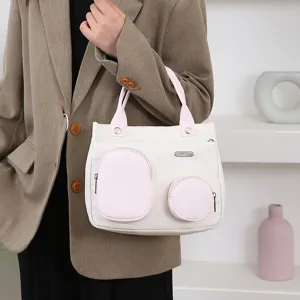 Stylish small handbag with pink and white contrast pockets, perfect for casual daily use.