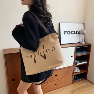 Large capacity canvas shoulder tote bag for women, stylish casual daily commuting bag.