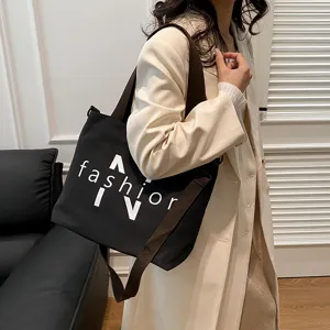 Large capacity black canvas tote bag for women, casual commuter shoulder bag with fashion print.
