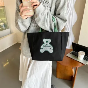 Korean style fashion black canvas tote bag with green handles and cute bear print for women.