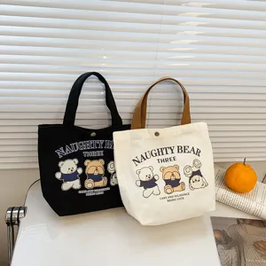 Canvas tote bag for women with cute bear print and button closure, casual daily shoulder bag.