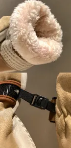 Detailed view of plush thick inner lining and secure anti-loss buckle on winter gloves.