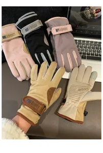 Close-up detail of winter suede gloves showing textured fabric, wrist strap and palm grip.