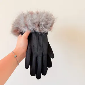Detailed view of women winter black gloves with fluffy fur cuff and three-rib design texture.