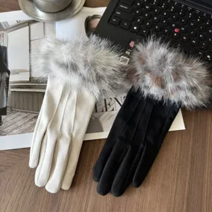 Close-up of women's winter warm gloves featuring soft suede fabric and luxurious plush fur cuffs.
