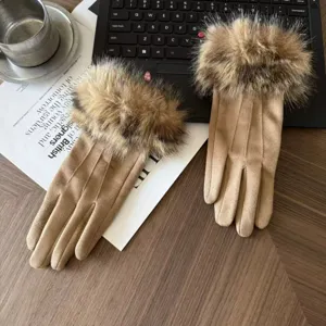 Detailed close-up of women's warm winter faux suede gloves with plush fur cuffs and stitching.