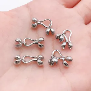 Closeup of silver-plated peppercorn hook clasps for DIY jewelry making and bracelet findings.